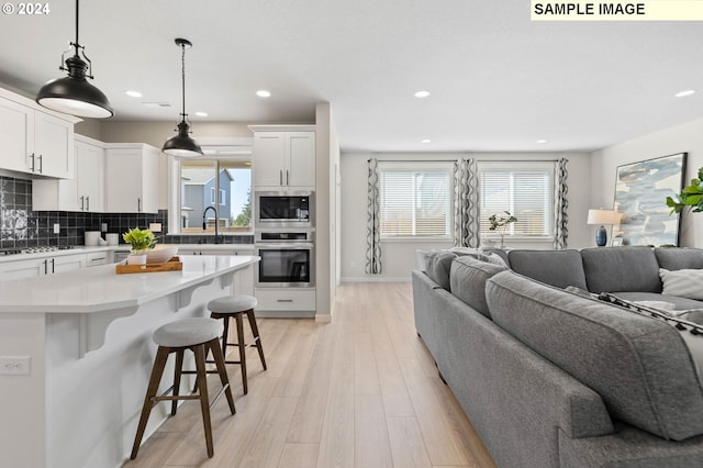 8510 NE 134th Ave Lot 87, Vancouver, WA 98685 - kitchen featuring appliances with stainless steel finishes, open floor plan, a breakfast bar, healthy amount of natural light, and recessed lighting