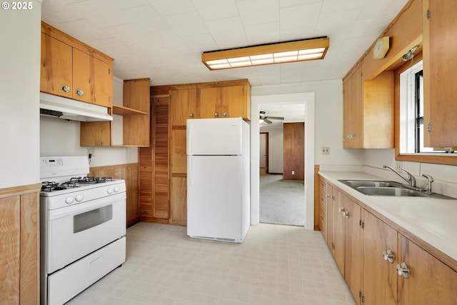 kitchen featuring ceiling fan, a sink, light countertops, under cabinet range hood, and white appliances
