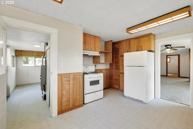 kitchen featuring white appliances, a ceiling fan, under cabinet range hood, and brown cabinetry