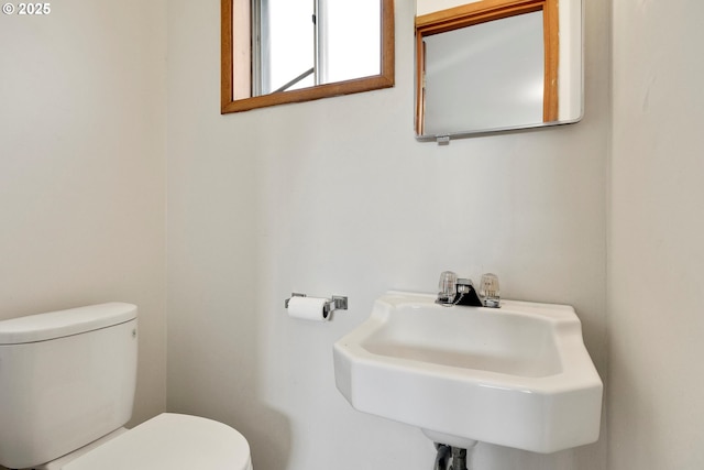 bathroom with toilet and a sink