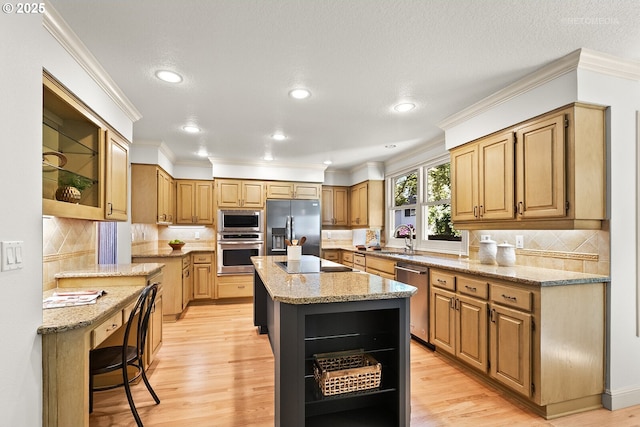 kitchen with appliances with stainless steel finishes, open shelves, a sink, a center island, and light stone countertops
