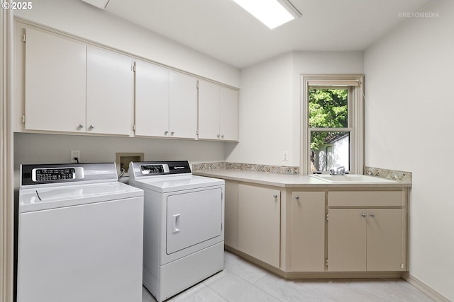 clothes washing area with cabinet space, washer and clothes dryer, and light tile patterned floors
