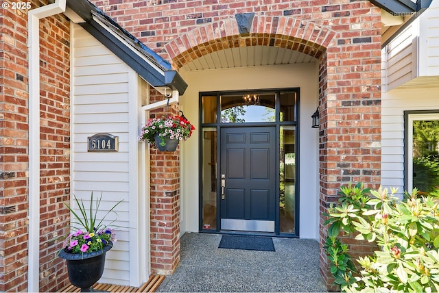 property entrance with brick siding