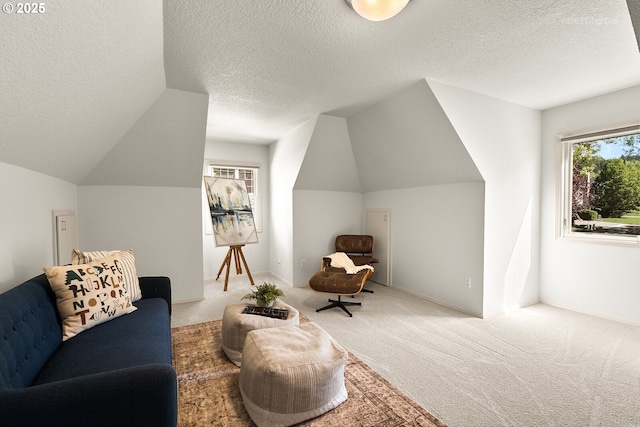 living area with a textured ceiling, vaulted ceiling, and carpet flooring