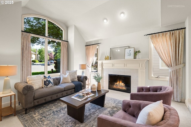 carpeted living room featuring a fireplace, high vaulted ceiling, baseboards, and recessed lighting