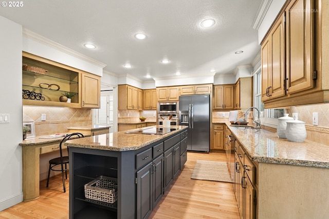kitchen featuring open shelves, appliances with stainless steel finishes, a sink, a center island, and light wood-type flooring