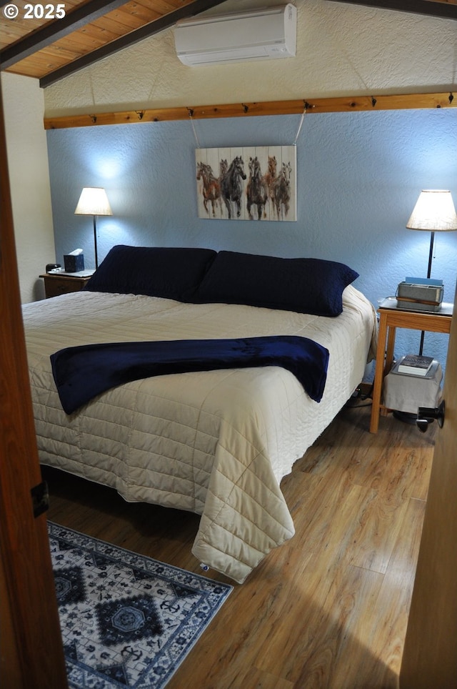 89016 Bridge St, Springfield, OR 97478 - bedroom with a wall mounted air conditioner, wood finished floors, and a textured wall