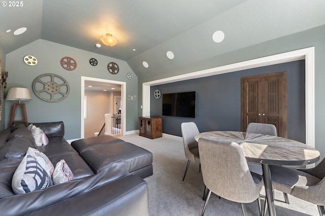 carpeted living area featuring lofted ceiling