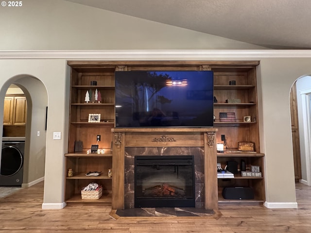 1809 Balm St, Baker City, OR 97814 - detailed view of washer / clothes dryer, arched walkways, wood finished floors, and a fireplace