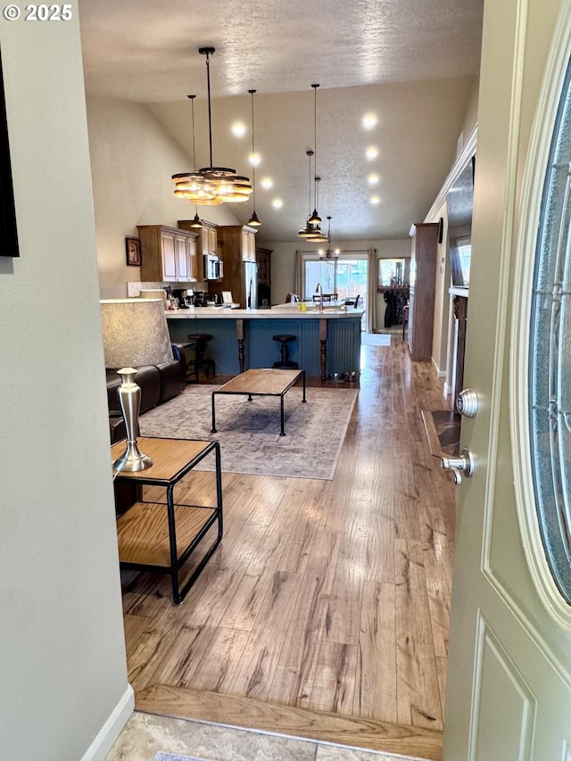 1809 Balm St, Baker City, OR 97814 - living area with vaulted ceiling, light wood finished floors, and a textured ceiling