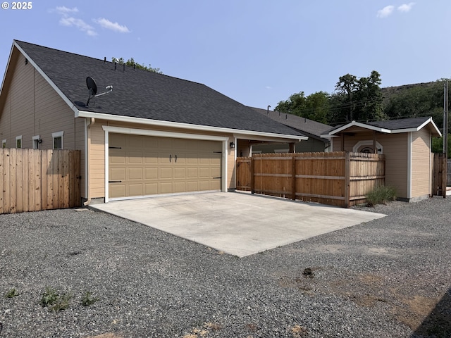 1809 Balm St, Baker City, OR 97814 - view of home's exterior with driveway, an attached garage, and roof with shingles
