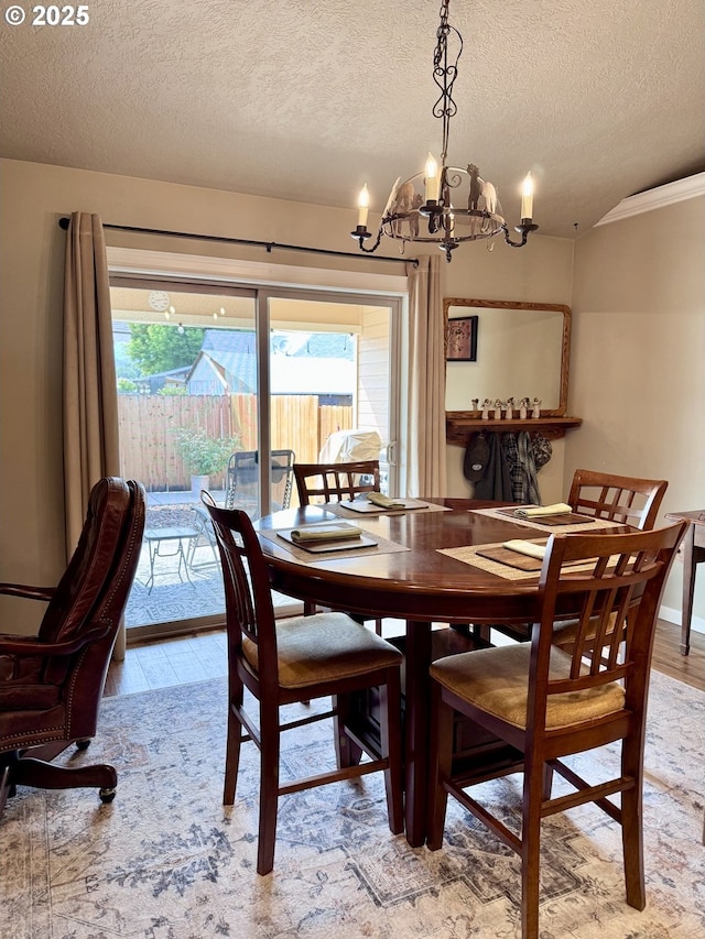 1809 Balm St, Baker City, OR 97814 - dining room featuring light wood-type flooring, a textured ceiling, a chandelier, healthy amount of natural light, and ornamental molding