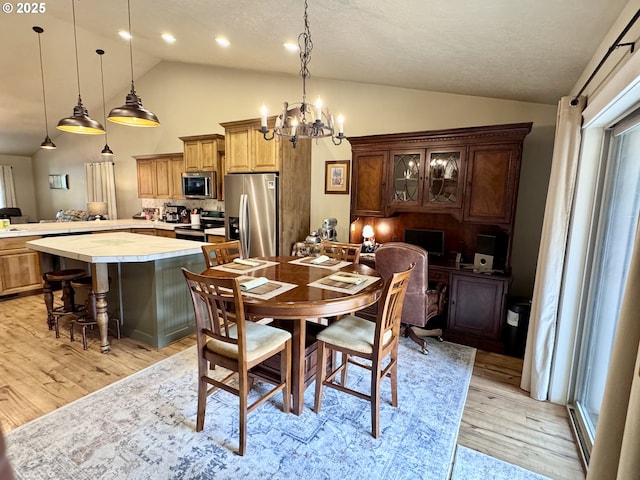 1809 Balm St, Baker City, OR 97814 - dining space featuring vaulted ceiling, light wood-type flooring, and a chandelier