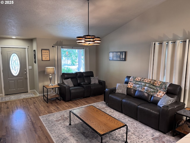 1809 Balm St, Baker City, OR 97814 - living room featuring wood finished floors, lofted ceiling, a chandelier, and a textured ceiling