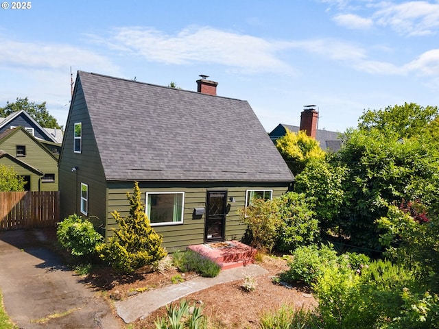 6736 N Haight Ave, Portland, OR 97217 - new england style home featuring a chimney and a shingled roof