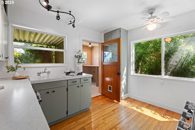 6736 N Haight Ave, Portland, OR 97217 - kitchen featuring a sink, ceiling fan, light countertops, and light wood-style floors