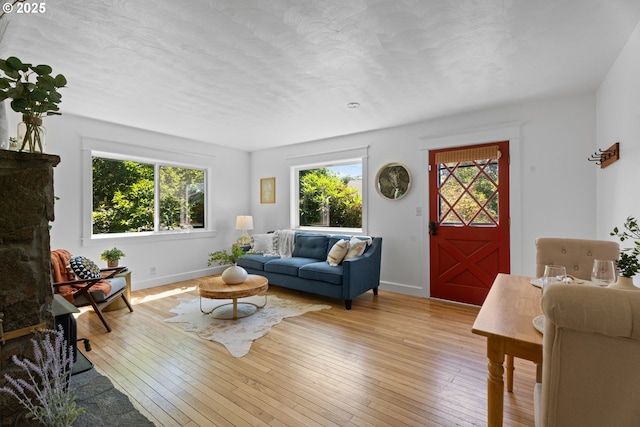 6736 N Haight Ave, Portland, OR 97217 - living room featuring baseboards, hardwood / wood-style flooring, a fireplace, and a textured ceiling