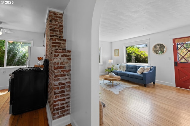 6736 N Haight Ave, Portland, OR 97217 - living area with hardwood / wood-style flooring, baseboards, arched walkways, and a ceiling fan