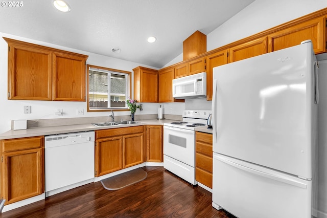 kitchen featuring dark wood-style flooring, recessed lighting, vaulted ceiling, a sink, and white appliances