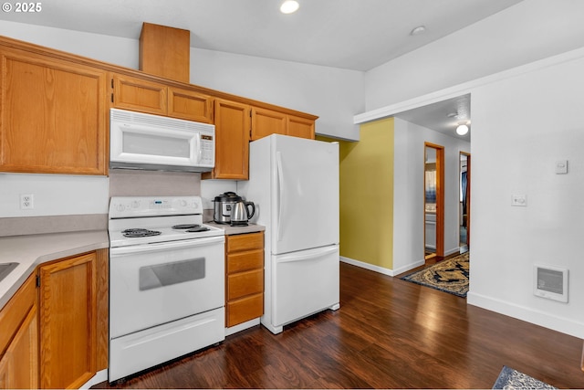 kitchen with white appliances, visible vents, dark wood-style floors, brown cabinets, and light countertops