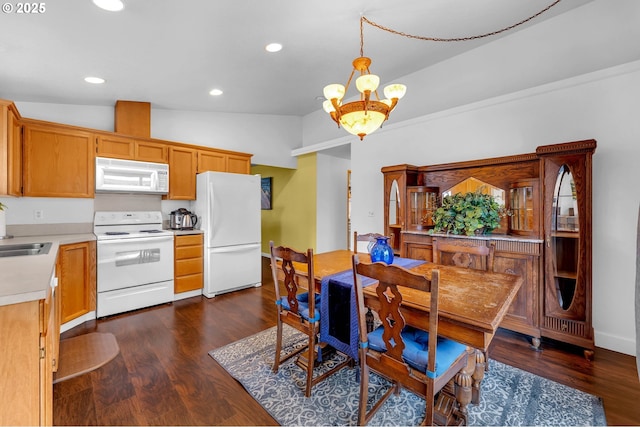 dining area with baseboards, dark wood-style floors, an inviting chandelier, vaulted ceiling, and recessed lighting