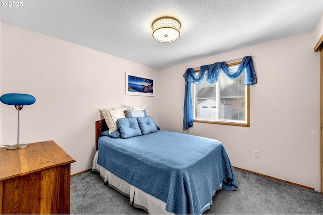 carpeted bedroom featuring a textured ceiling and baseboards