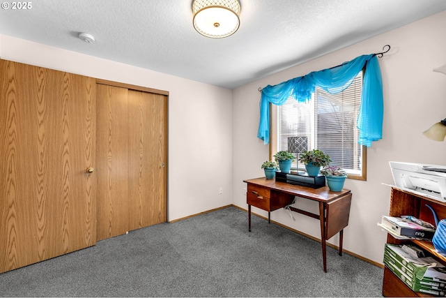 carpeted home office with a textured ceiling and baseboards