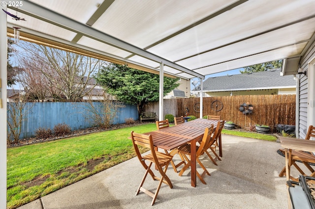 view of patio with a fenced backyard and outdoor dining area