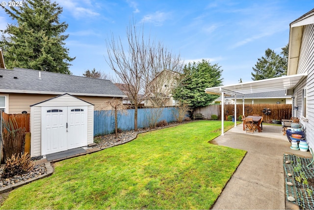 view of yard with a patio area, an outdoor structure, a fenced backyard, and a storage shed