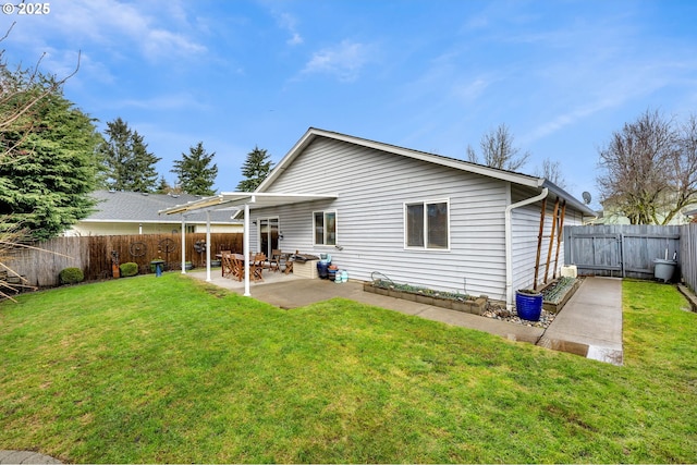 back of property featuring a patio area, a yard, and a fenced backyard