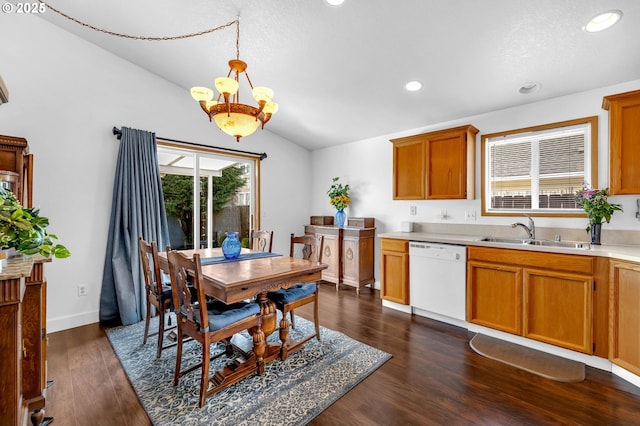 kitchen featuring dark wood-style flooring, a sink, vaulted ceiling, light countertops, and dishwasher