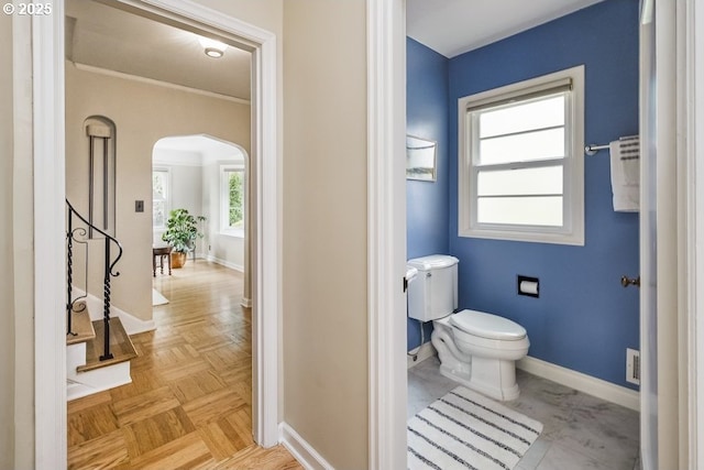 8100 SW 6th Ave, Portland, OR 97219 - bathroom featuring baseboards, toilet, and ornamental molding