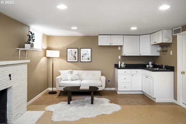 8100 SW 6th Ave, Portland, OR 97219 - living area with a fireplace, baseboards, light tile patterned floors, and recessed lighting
