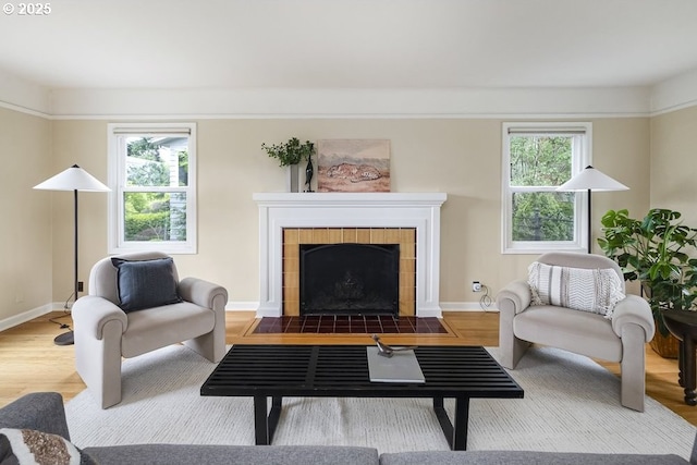 8100 SW 6th Ave, Portland, OR 97219 - living room with a tiled fireplace, wood finished floors, and baseboards