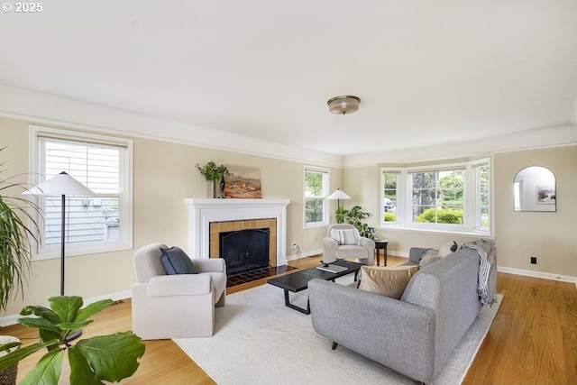 8100 SW 6th Ave, Portland, OR 97219 - living area featuring a fireplace, light wood-style flooring, and baseboards