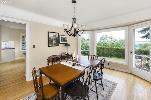8100 SW 6th Ave, Portland, OR 97219 - dining room with baseboards, a chandelier, and light wood-style flooring