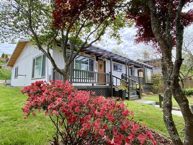 156 1st Ave, Coos Bay, OR 97420 - view of front facade with a front yard and board and batten siding