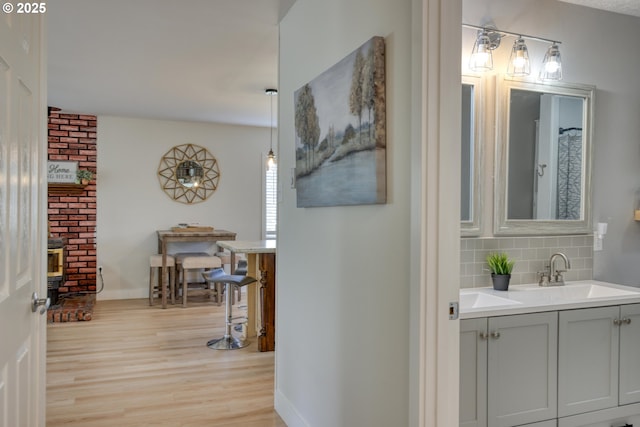 156 1st Ave, Coos Bay, OR 97420 - hallway featuring light wood-style flooring, a sink, and baseboards