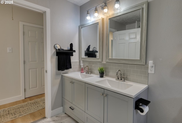 156 1st Ave, Coos Bay, OR 97420 - bathroom featuring tasteful backsplash, double vanity, and baseboards