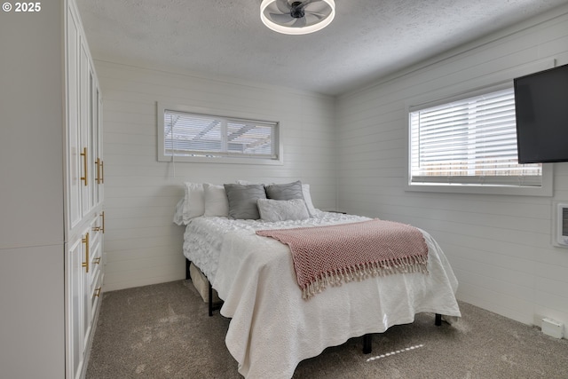 156 1st Ave, Coos Bay, OR 97420 - carpeted bedroom featuring a textured ceiling and wood walls
