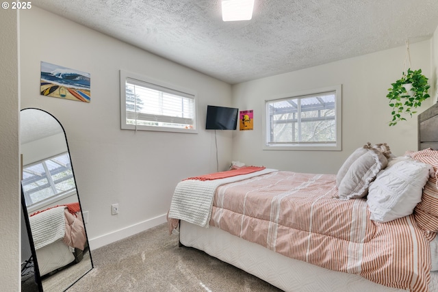 156 1st Ave, Coos Bay, OR 97420 - bedroom featuring carpet floors, multiple windows, baseboards, and a textured ceiling