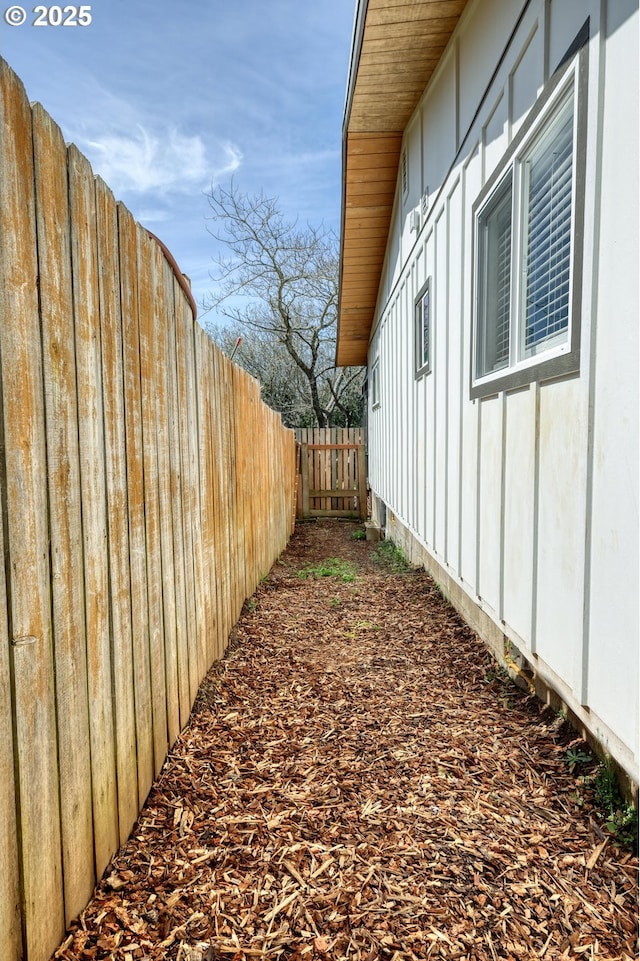 156 1st Ave, Coos Bay, OR 97420 - view of side of home featuring board and batten siding and fence