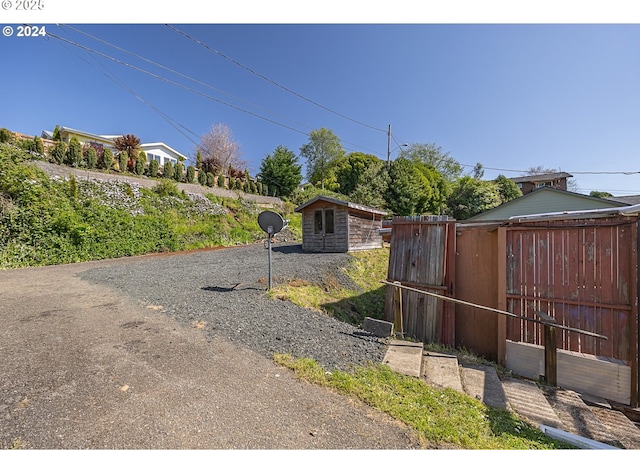 156 1st Ave, Coos Bay, OR 97420 - view of yard with fence, an outbuilding, a shed, and a gate