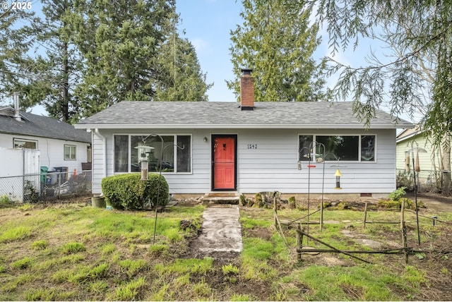 view of front of house with a front lawn, fence, a chimney, and crawl space