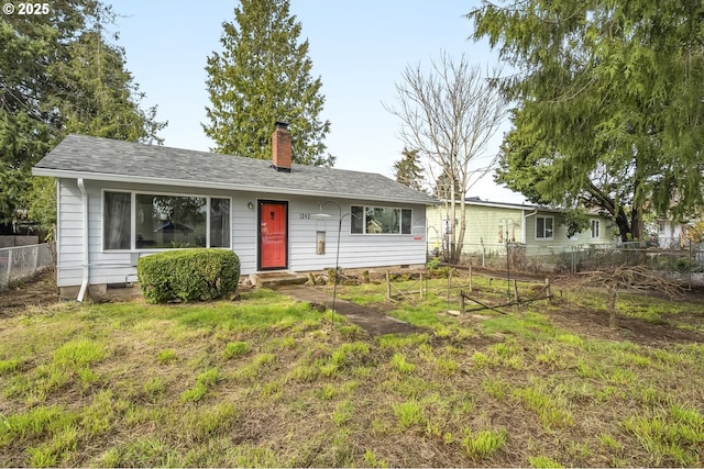 ranch-style house featuring fence, roof with shingles, a front yard, crawl space, and a chimney