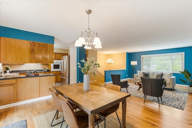 11995 SW 119th Ave, Portland, OR 97223 - dining space featuring a chandelier and light wood-style flooring
