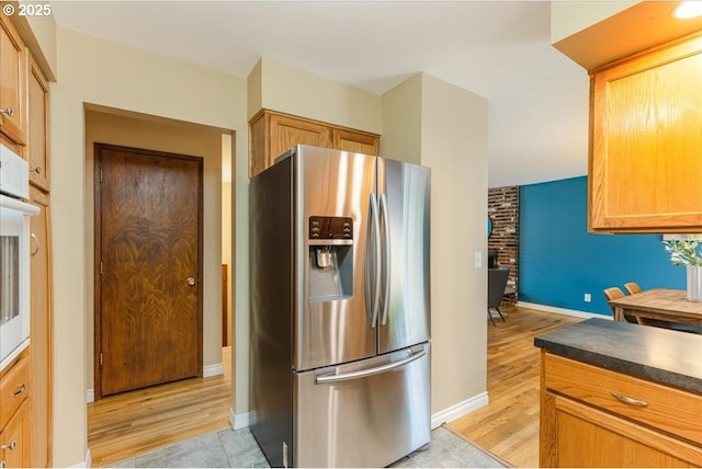 11995 SW 119th Ave, Portland, OR 97223 - kitchen with stainless steel fridge, dark countertops, light wood-style floors, and oven