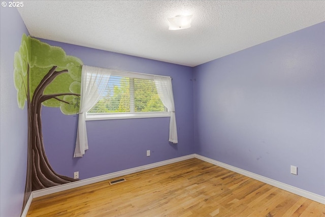 11995 SW 119th Ave, Portland, OR 97223 - unfurnished room featuring wood finished floors and a textured ceiling