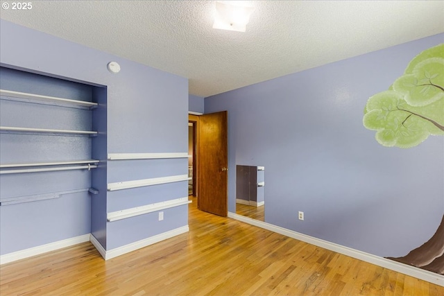 11995 SW 119th Ave, Portland, OR 97223 - unfurnished bedroom featuring wood finished floors, a closet, and a textured ceiling