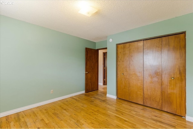 11995 SW 119th Ave, Portland, OR 97223 - unfurnished bedroom with light wood finished floors, a closet, and a textured ceiling